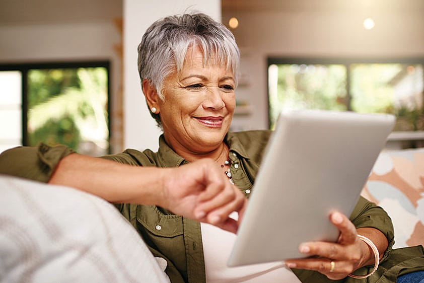 A Qurate Health member using a tablet for a virtual care visit at home